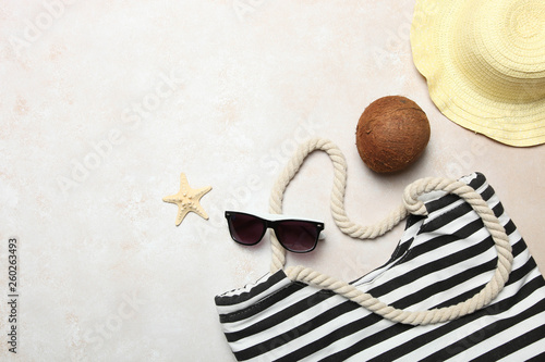 Striped beach bag, straw hat, sunglasses