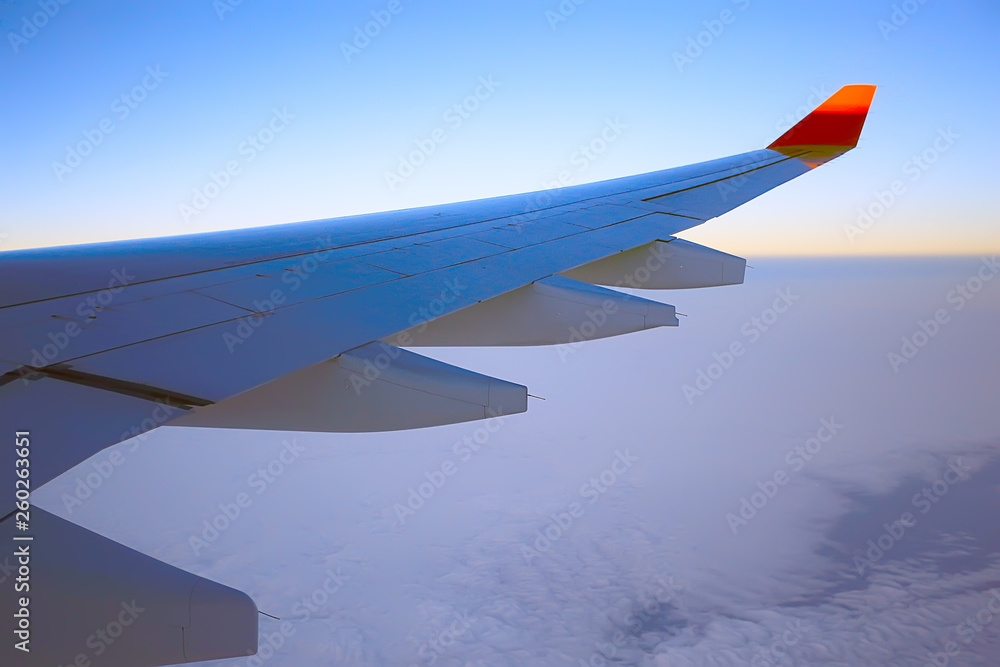 Fototapeta premium wing airplane view of sky / blue sky and wing of an airplane, view from the cabin of an airplane, concept of air transport