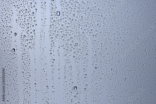 gray wet background / raindrops to overlay on the window, weather, background drops of water rain on the glass transparent