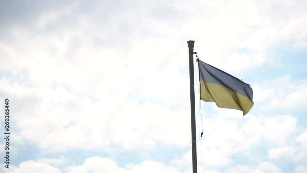 Flag of Ukraine. against blue sky, flag installed on flagpole in Kyiv Flag of Ukraine. against blue sky, flag installed on flagpole in Kyiv