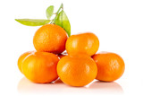 Lot of whole fresh orange mandarine with green leaves isolated on white background