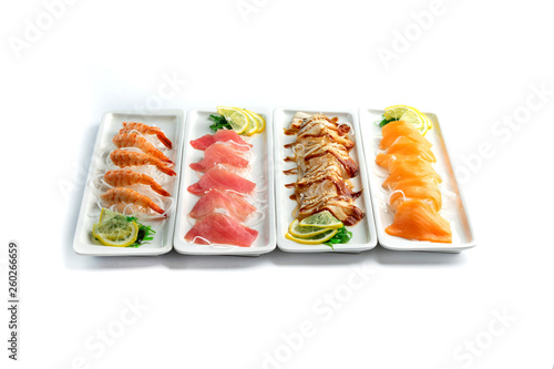 assorted japanese food dishes on rectangular plates on an isolated white background