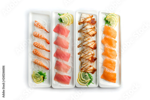 assorted japanese food dishes on rectangular plates on an isolated white background