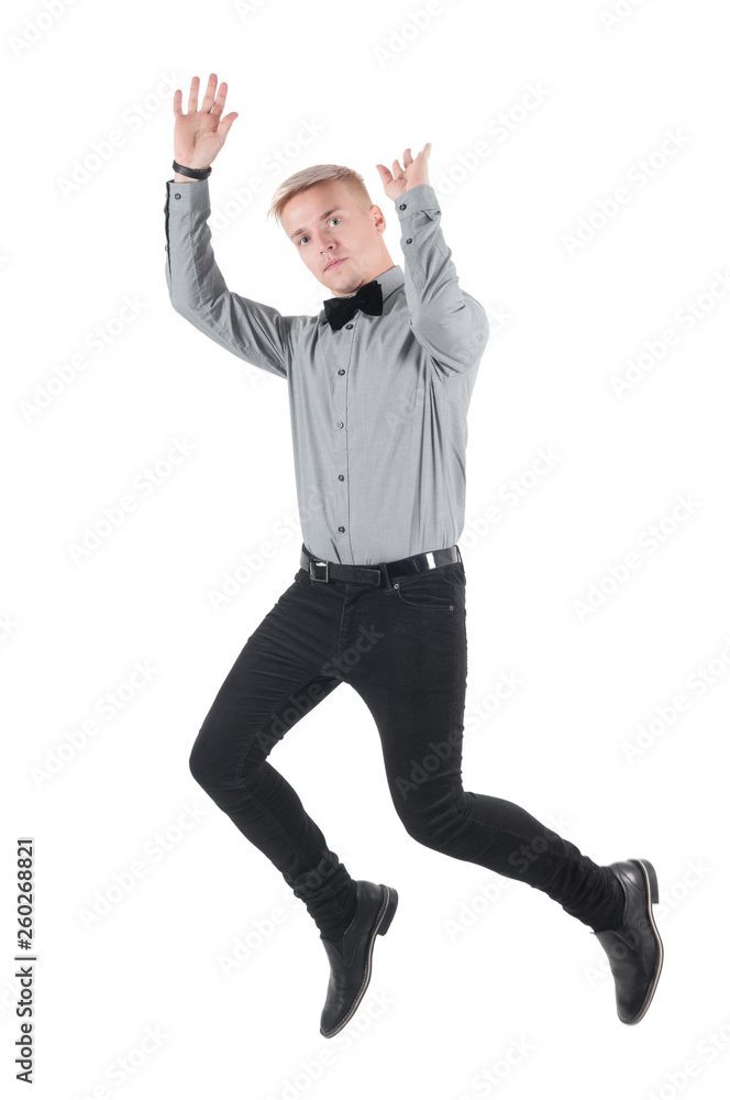 Handsome man in shirt and bow-tie jumping