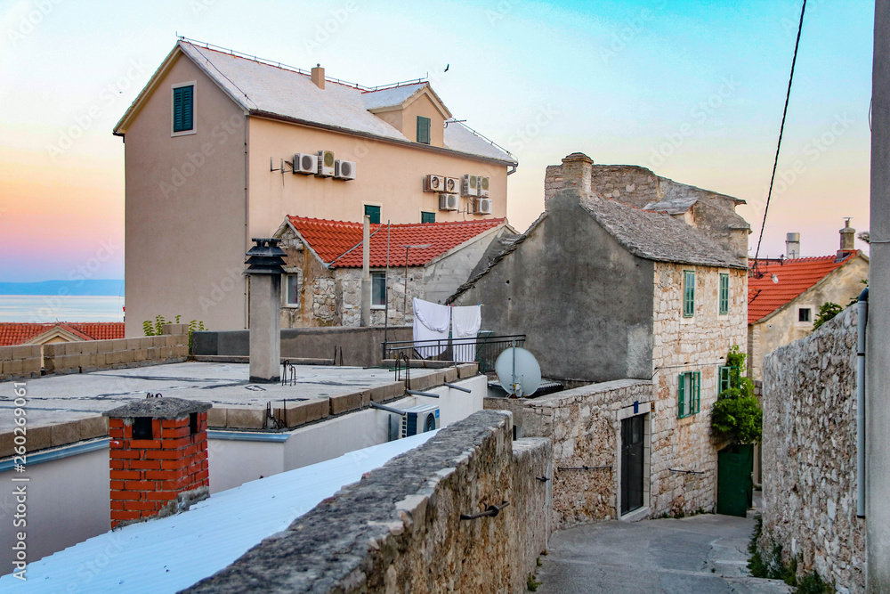Typical stone houses on small street in Bol old town, Brac island, Croatia