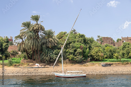 Faluca boat moored in Nile river at Aswan, Egypt photo