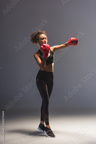 beautiful athletic african american sportswoman boxing on black © LIGHTFIELD STUDIOS
