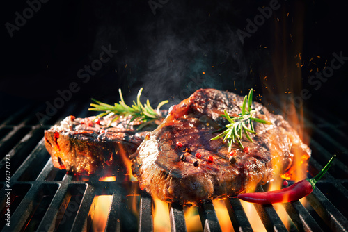 Beef steaks sizzling on the grill