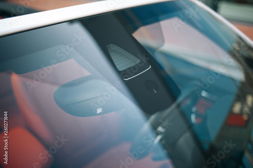 Rain and light sensor on the windshield of the car