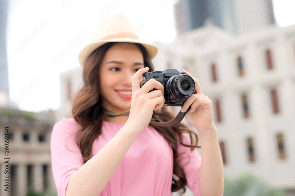 Outdoor summer smiling lifestyle portrait of pretty young woman having fun in the city in Asian with camera travel photo of photographer Outdoor summer smiling lifestyle portrait of pretty young woman having fun in the city in Asian with camera travel photo of photographer