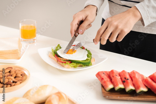 A man having breakfast with knife and fork