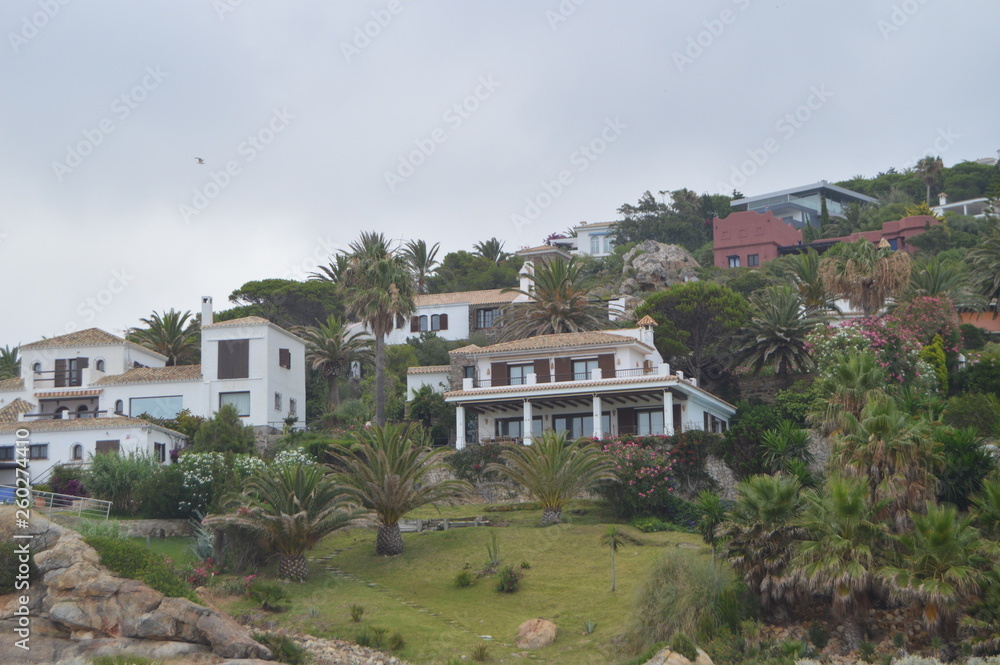 Obraz premium Picturesque Houses On The Cliff Of Atlanterra Beach In Zahara. Nature, Architecture, History, Street Photography. July 12, 2014. Zahara De Los Atunes, Cadiz, Spain