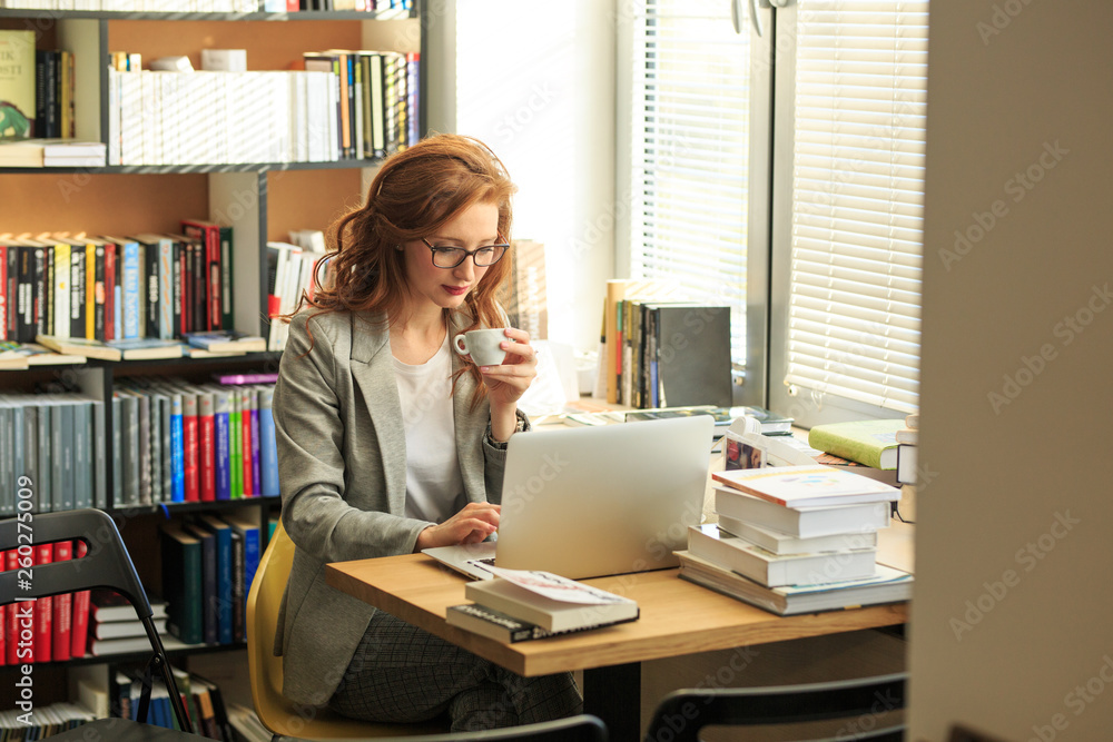 In her office, a dedicated female professor meticulously inspects tests, reviewing each student's progress with care and dedication, ensuring a fair and thorough evaluation process. In her office, a dedicated female professor meticulously inspects tests, reviewing each student's progress with care and dedication, ensuring a fair and thorough evaluation process.