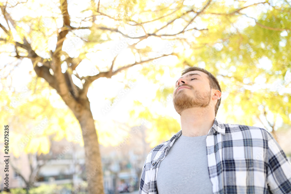 Man relaxing breathing deep fresh air in a park Man relaxing breathing deep fresh air in a park