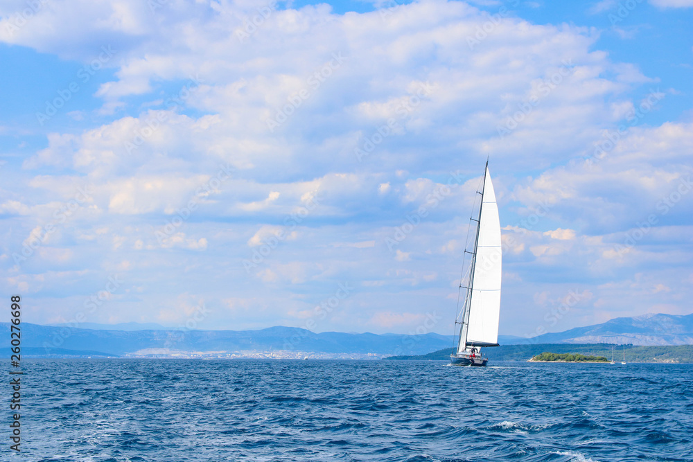 large sailboat in the Adriatic sea on blue and cloud sky background