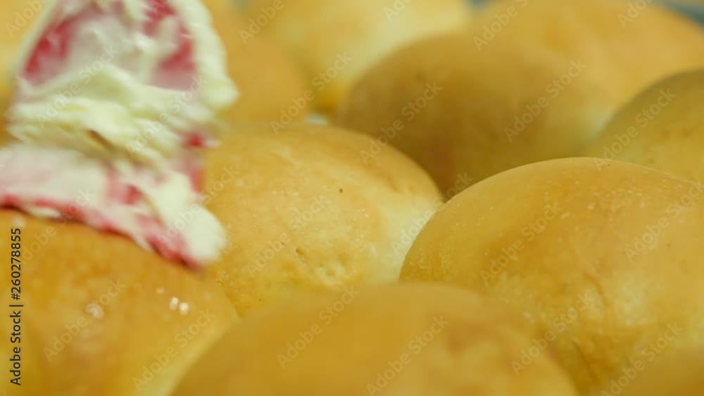 close up of kolache baked round bread gets coated in butter slow motion. Slow motion clip of bread being brushed with melted butter. close up of kolache baked round bread gets coated in butter slow motion. Slow motion clip of bread being brushed with melted butter.