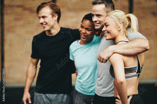 Diverse friends smiling in a gym after working out class