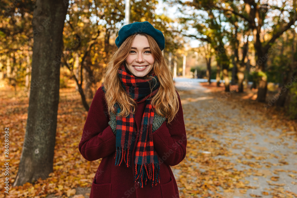Cheerful young girl with long brown hair wearing autumn Cheerful young girl with long brown hair wearing autumn
