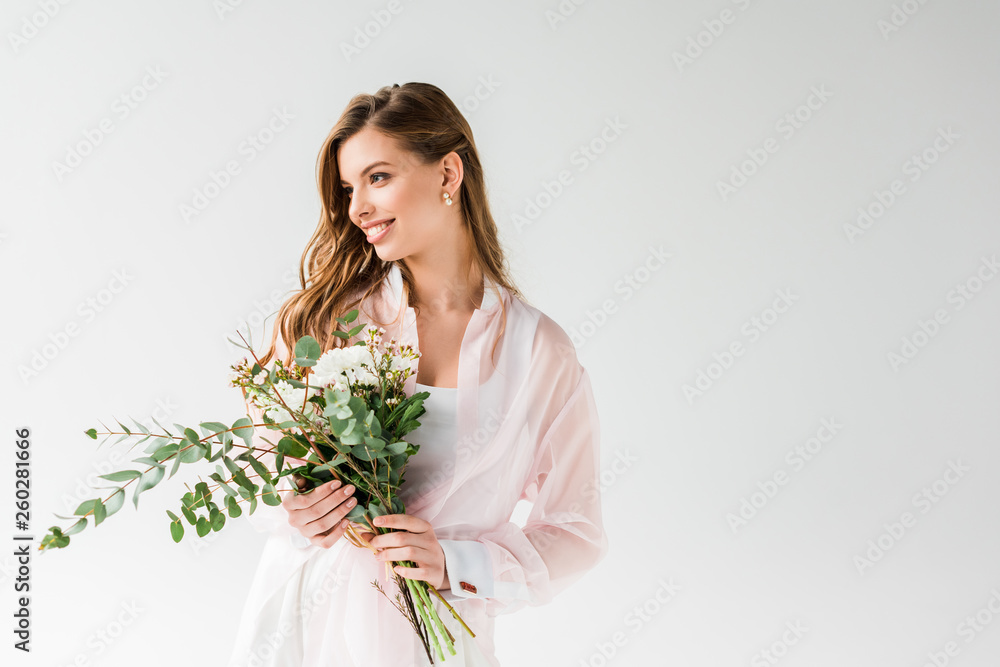 cheerful girl holding flowers and green eucalyptus leaves on white cheerful girl holding flowers and green eucalyptus leaves on white