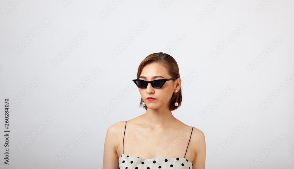 Fototapeta premium Chinese Girl wearing varies types of fashion sunglasses,looking sharp