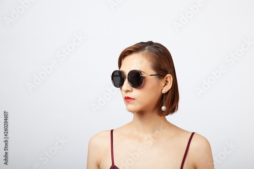 Chinese Girl wearing varies types of fashion sunglasses,looking sharp