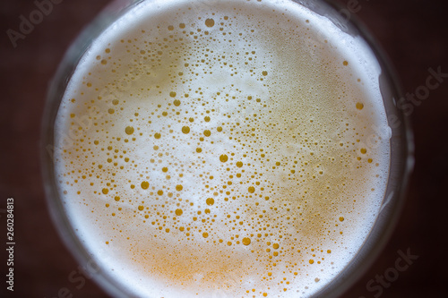 Close up top view bubble froth of beer on glasses photo