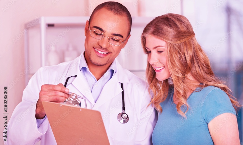 Young doctor with beautiful woman showing good results Young doctor with beautiful woman showing good results