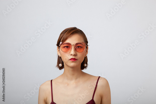 Chinese Girl wearing varies types of fashion sunglasses,looking sharp