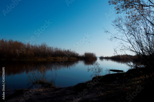 Fototapeta Naklejka Na Ścianę i Meble -  Autumn day in Arkhangelsk. Island Krasnoflotsky. the reflection in the water