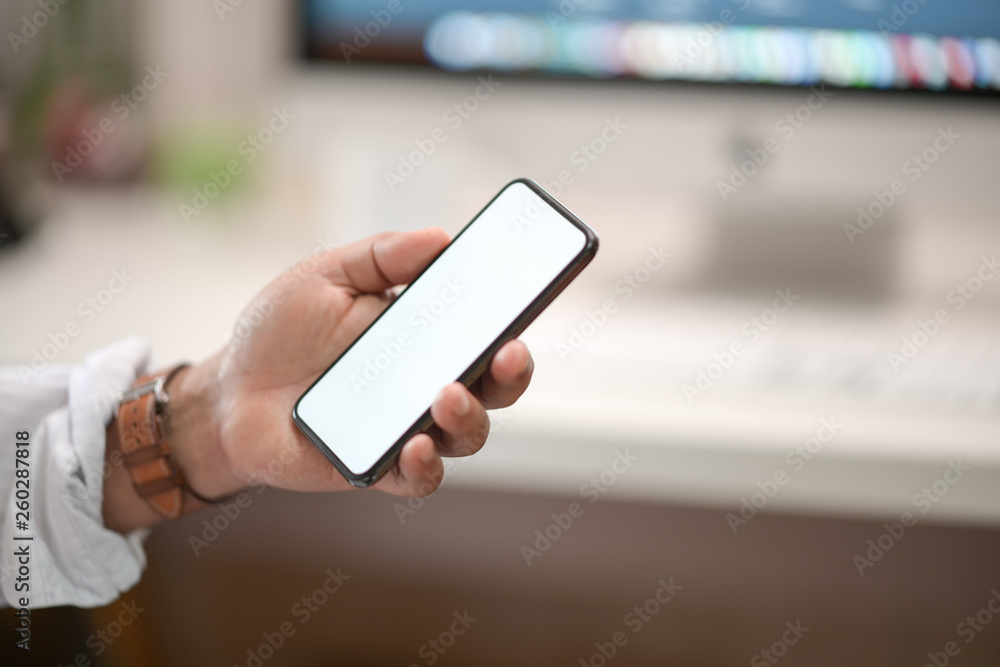 Business man showing blank screen mobile phone in office Business man showing blank screen mobile phone in office