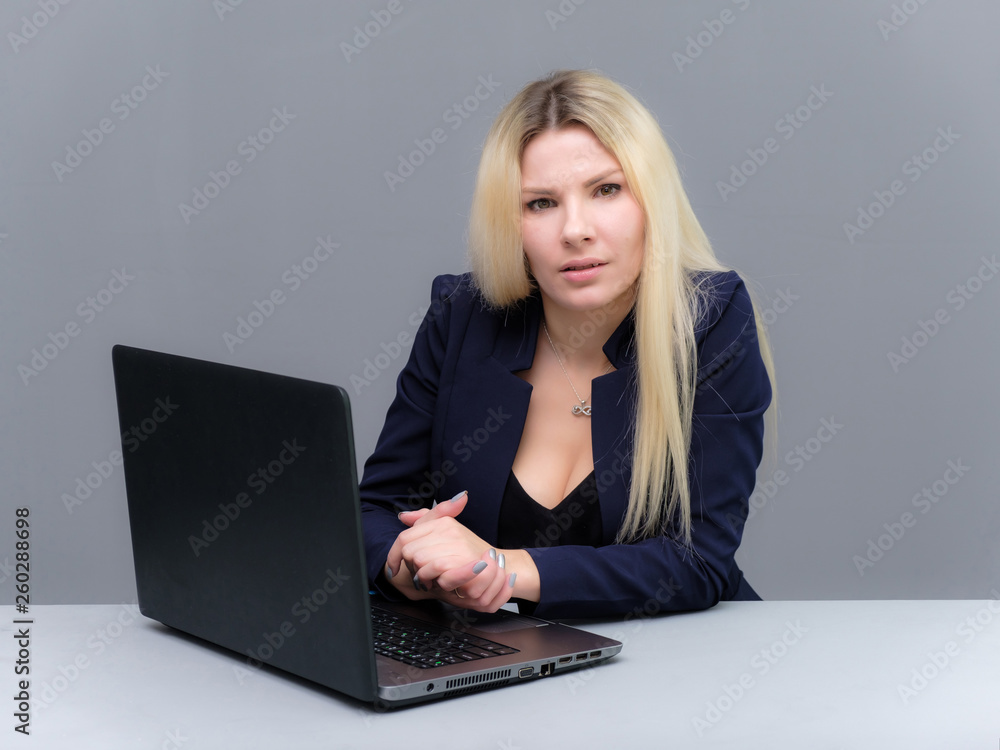 Portrait of happy smiling young cheerful businesswoman sitting with a laptop. Success in business concept studio shot talking to a client. Portrait of happy smiling young cheerful businesswoman sitting with a laptop. Success in business concept studio shot talking to a client.