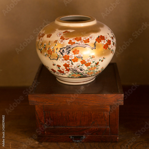 White porcelain Japanese vase decorated with dark wood background