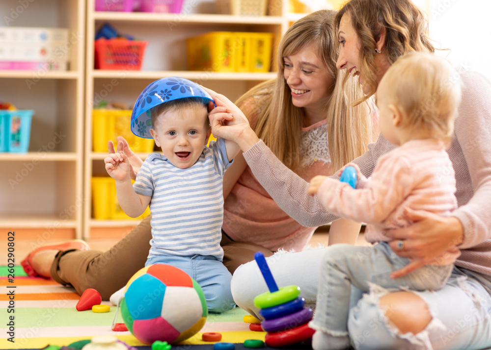Mothers with kids play in playroom Mothers with kids play in playroom