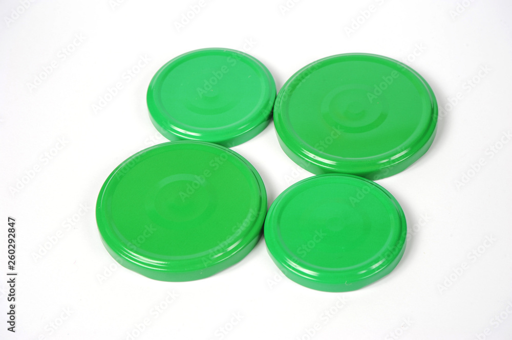 Screw caps for glass jars. For canning, canned food. Green caps on white background Screw caps for glass jars. For canning, canned food. Green caps on white background