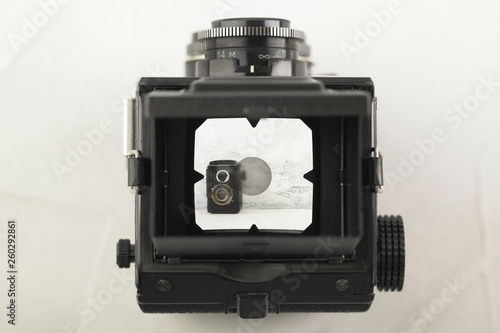 The old medium format film TLR camera, camera for modern lomography on white cement background. photo