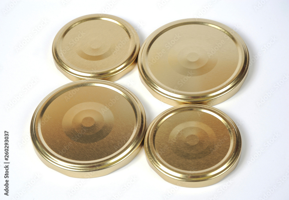 Screw caps for glass jars. For canning, canned food. Golden caps on white background Screw caps for glass jars. For canning, canned food. Golden caps on white background
