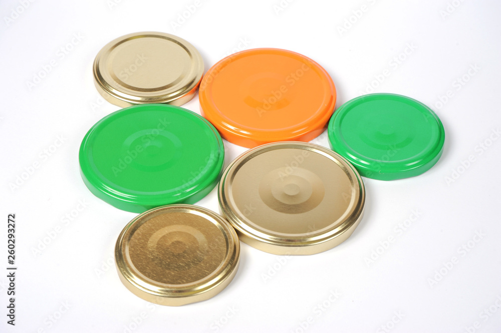 Screw caps for glass jars. For canning, canned food. Orange, green, golden caps on white background