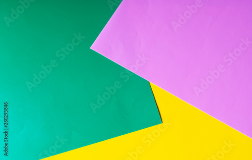 Multicolored horizontal background, colored cardboard. Yellow, green and purple. Copy space