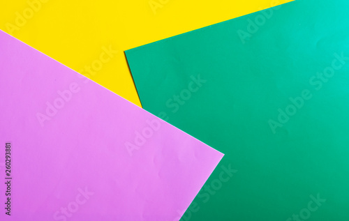 Multicolored horizontal background, colored cardboard. Yellow, green and purple. Copy space