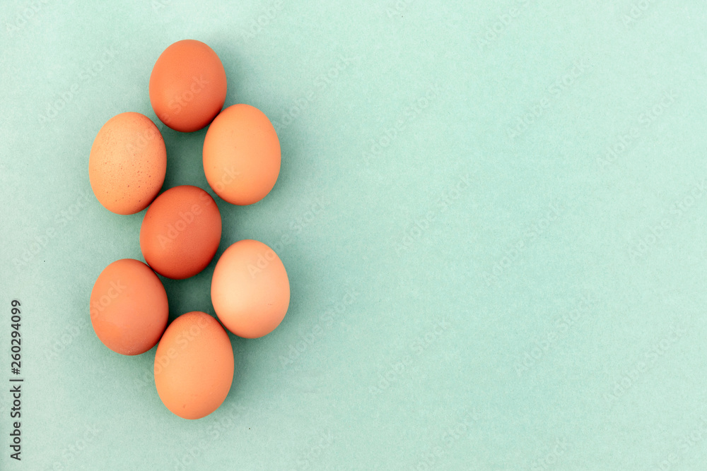 Blue background with chicken eggs. Top view with copy space.