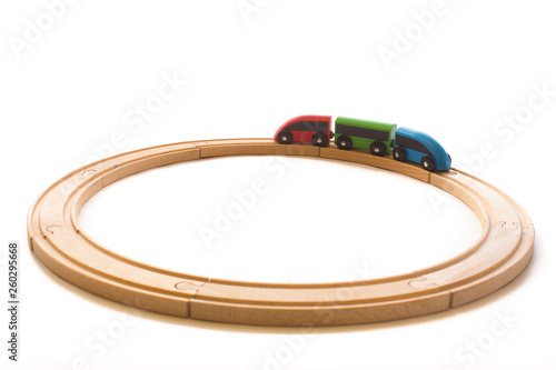 Wooden colorful toys for children with train and railway road isolated on the white background.