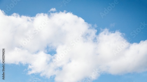 Fluffy big white cloud on the blue sky background. 16:9