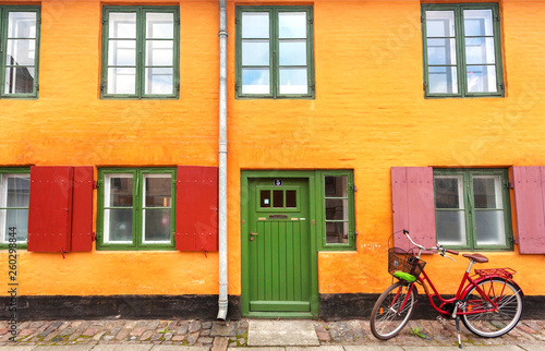 Colorful house and parked bicycle in historical area of city