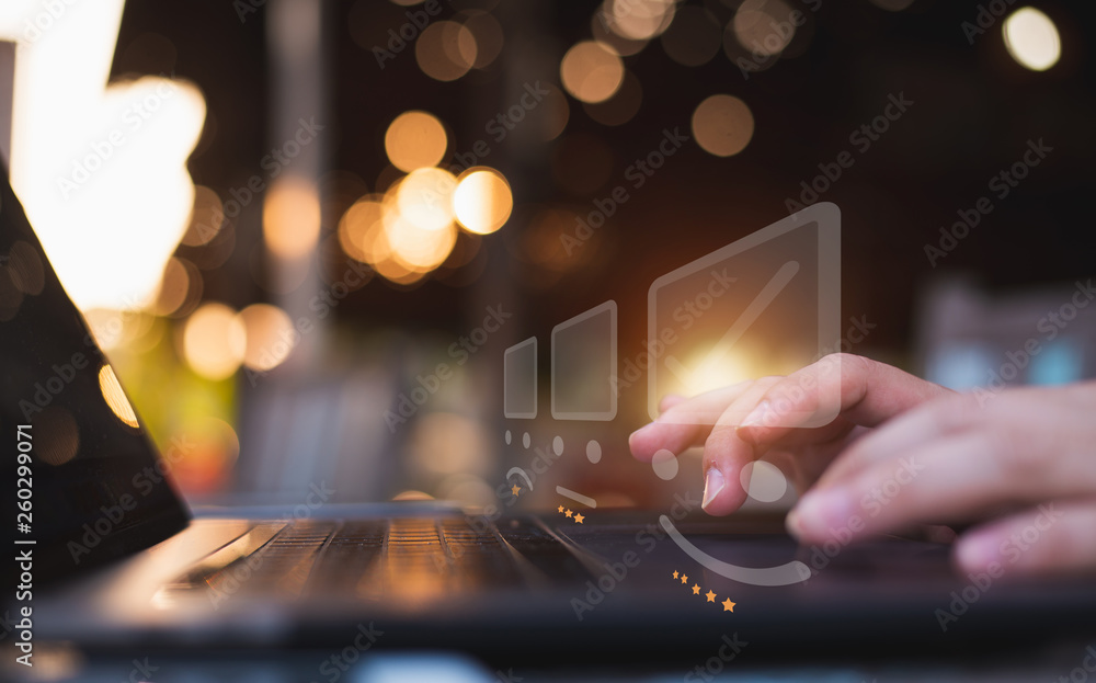 Businessman pressing face emoticon on the keyboard laptop and checklist service report on online shop / Customer service evaluation concept. Businessman pressing face emoticon on the keyboard laptop and checklist service report on online shop / Customer service evaluation concept.