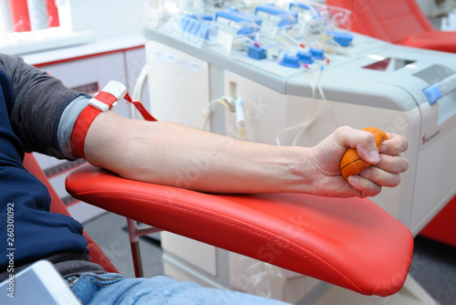Preparing for taking blood from vain. Arm pressing ball for better blood pressure