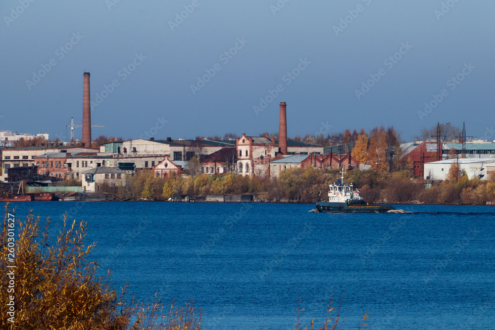 Arkhangelsk. Autumn day. View of the old buildings and berths of the timber processing plant 