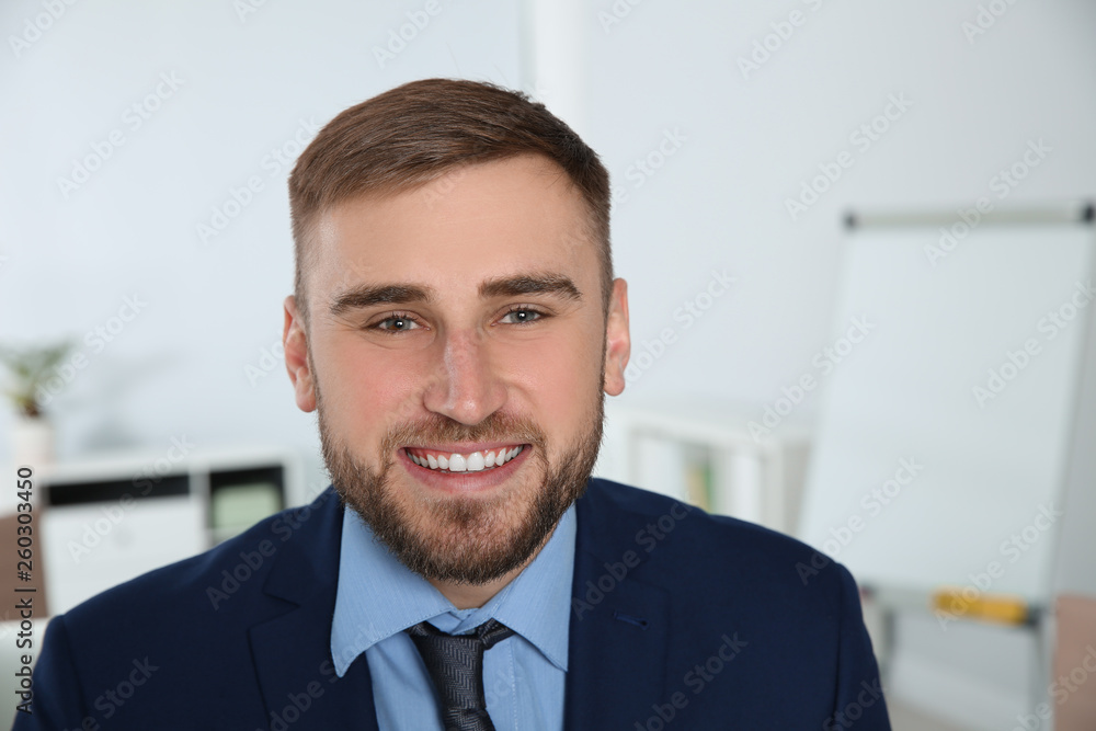 Portrait of young businessman laughing at workplace Portrait of young businessman laughing at workplace