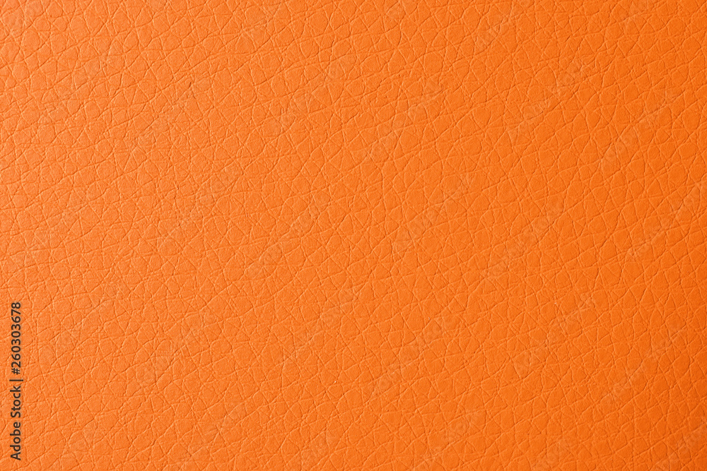 Fototapeta premium Texture of orange leather as background, closeup