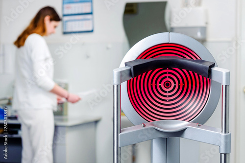 Ophthalmological equipment in the clinic. In the background medical staff.