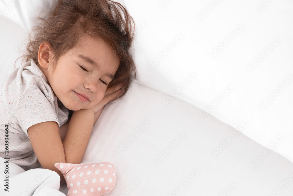 Cute little girl with toy sleeping in bed Cute little girl with toy sleeping in bed